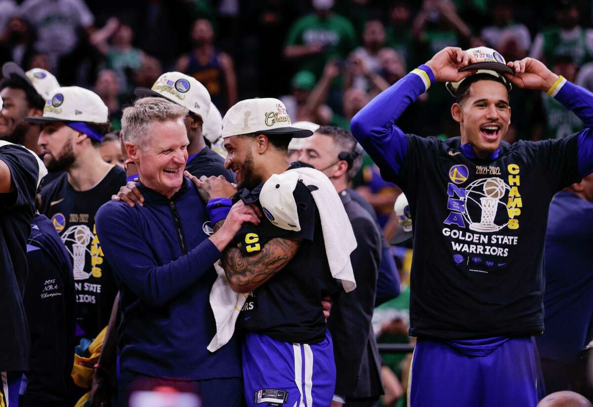 Coach Steve Kerr celebrates with Gary Payton II after the Warriors won the NBA crown. As a player and coach, Kerr has won nine titles.