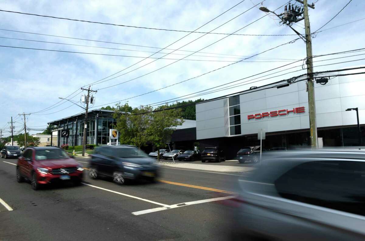 Traffic passes by a stretch of several car dealerships and repair shops along West Putnam Avenue in Greenwich, Conn. Monday, Jun 13, 2022. Car thefts are on the rise and five vehicles were stolen over the weekend.