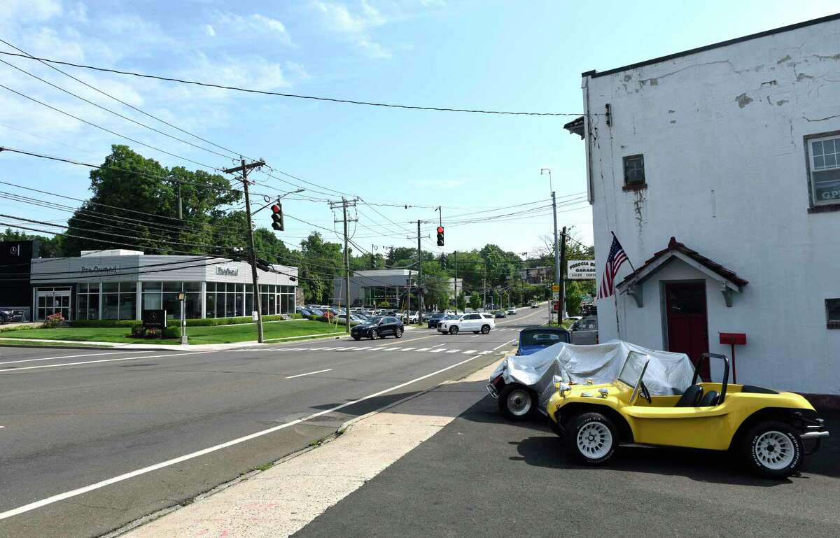 Traffic passes by a stretch of several car dealerships and repair shops along West Putnam Avenue in Greenwich, Conn. Monday, Jun 13, 2022. Car thefts are on the rise and five vehicles were stolen over the weekend.