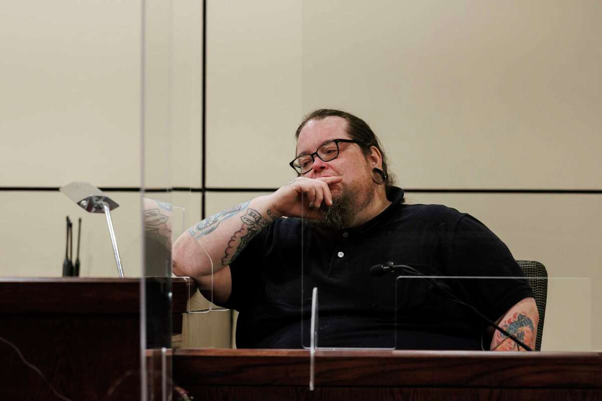 John Parker pauses to reflect as he testifies Friday during a hearing on whether his father, Melvin George Quinney Jr., should have his 1991 conviction for indecency with a child overturned. Parker was 9 years old in 1989, when he accused his father of satanic ritual abuse, and now he is recanting his original testimony.