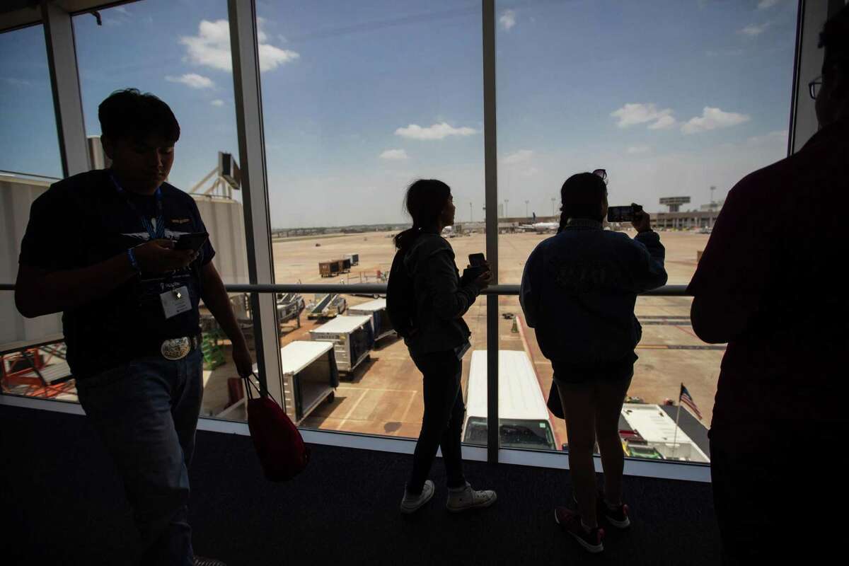 Students take photos of George Bush Intercontinental Airport gate system after participating in the United Airlines “Juneteenth Flight” from Houston to Galveston, Thursday, June 16, 2022. During the flight, a member of the aircraft crew shared with the students the story of Juneteenth and its significance. About 100 students participated in the flight.