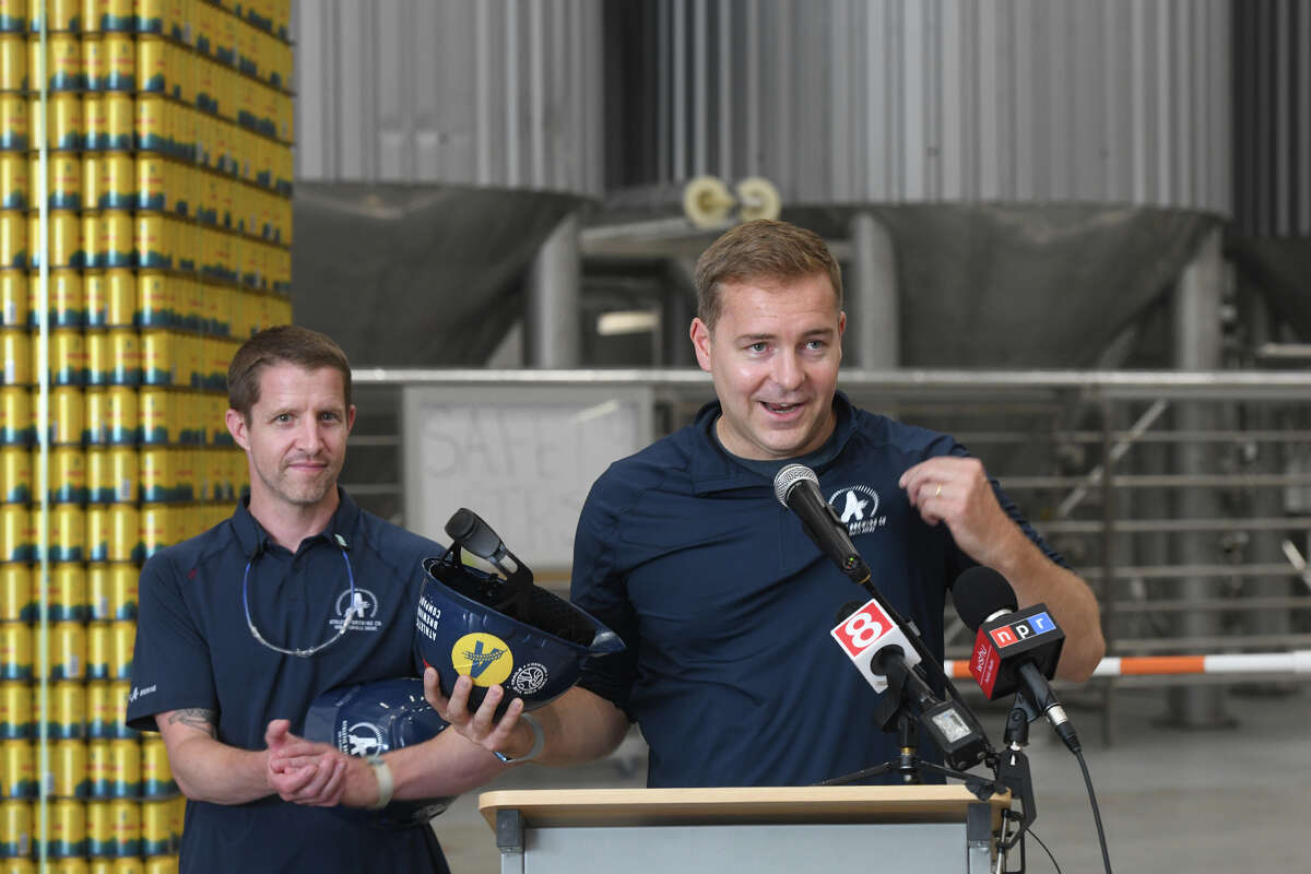 Co-founders Bill Shufelt, right, and John Walker speak during a ribbon cutting ceremony at Athletic Brewing Company’s new brewery, in Milford, Conn. June 17, 2022.