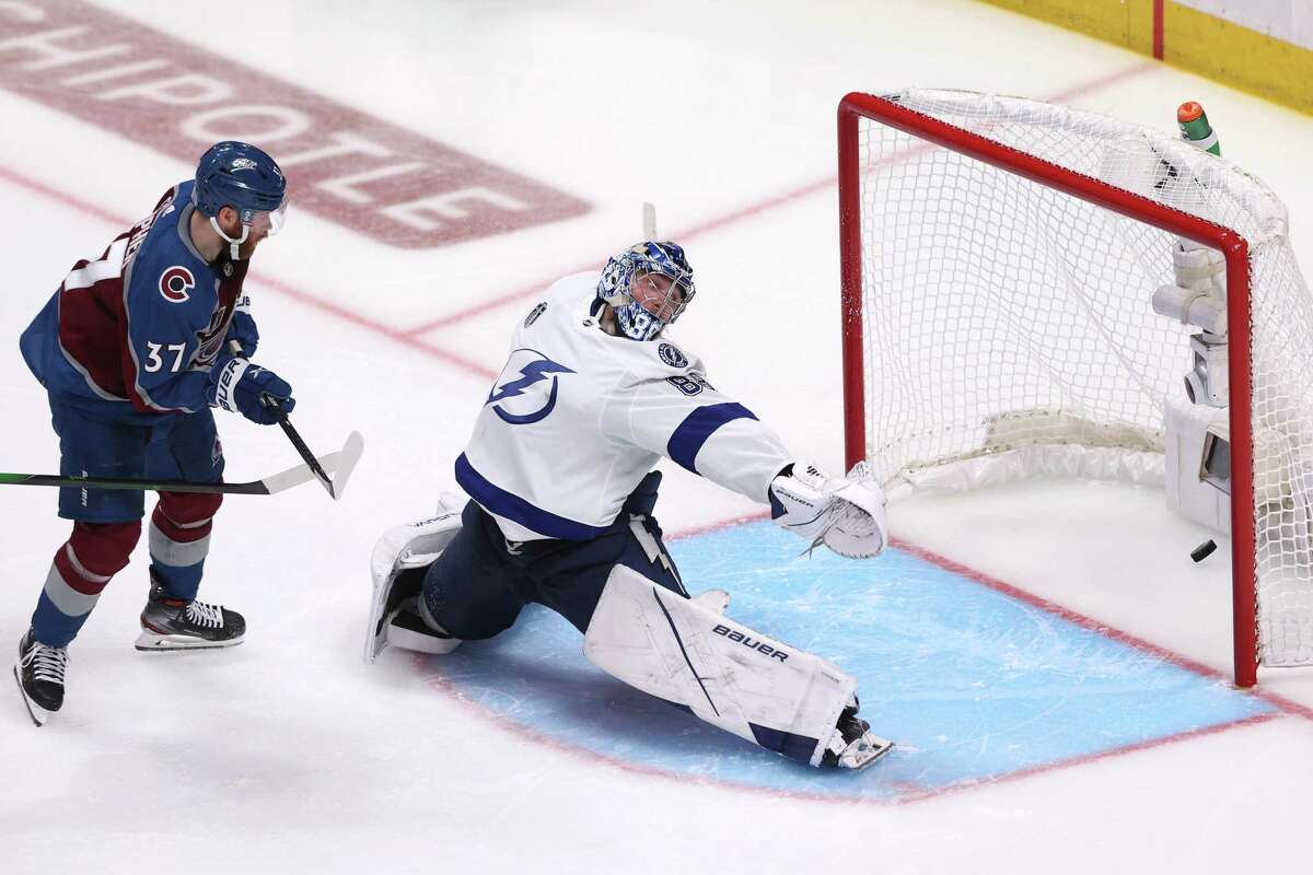 DENVER, COLORADO - JUNE 15: Andre Burakovsky #95 of the Colorado Avalanche scores a goal against Andrei Vasilevskiy #88 of the Tampa Bay Lightning during overtime to win Game One of the 2022 Stanley Cup Final 4-3 at Ball Arena on June 15, 2022 in Denver, Colorado. (Photo by Harry How/Getty Images) *** BESTPIX ***