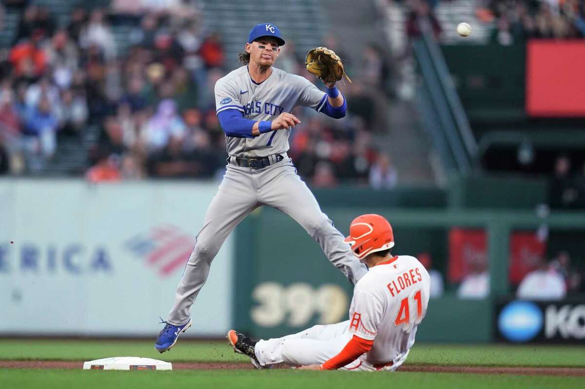 Kansas City Royals shortstop Bobby Witt Jr. watches his throw to first after forcing out San Francisco Giants' Wilmer Flores at second base on a double play hit into by Darin Ruf during the fourth inning of a baseball game in San Francisco, Tuesday, June 14, 2022. (AP Photo/Jeff Chiu)