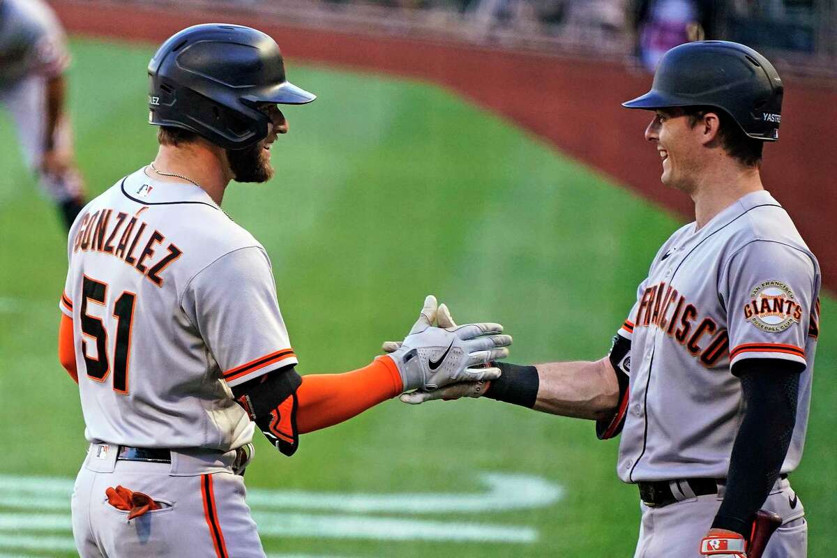 San Francisco Giants' Luis Gonzalez (51) is greeted by Mike Yastrzemski as he returns to the dugout after hitting a solo home run off Pittsburgh Pirates starting pitcher Zach Thompson during the first inning of a baseball game in Pittsburgh, Friday, June 17, 2022. (AP Photo/Gene J. Puskar)