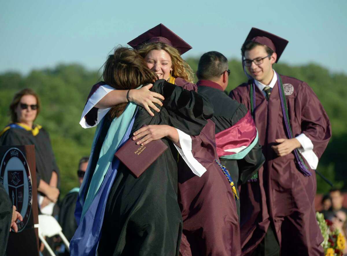 Ruby Jean Ackerman gets a hug after receiving her diploma during the 2022 Bethel High School Graduation, Friday, June 17, 2022, Bethel, Conn.