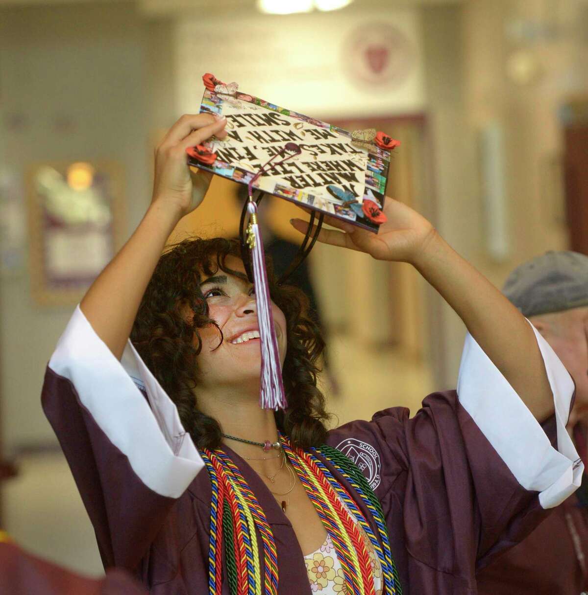 Ava Graham tries to put on her cap before the 2022 Bethel High School Graduation, Friday, June 17, 2022, Bethel, Conn.