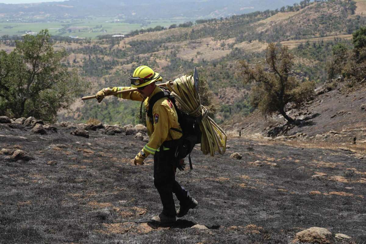 St. Helena firefighters check on smoldering trees this month in Napa from the Old Fire, an early season blaze that ignited in a region prone to fire.