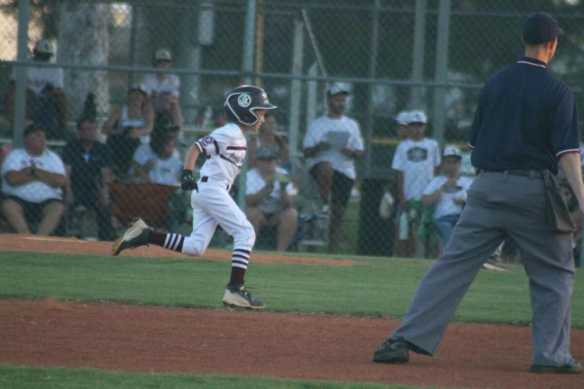 League City White all-star Kannon Vaughan hustles to third base as he takes advantage of a wild pitch in Friday night's District 14 opener at Rudy Trabanino Field.