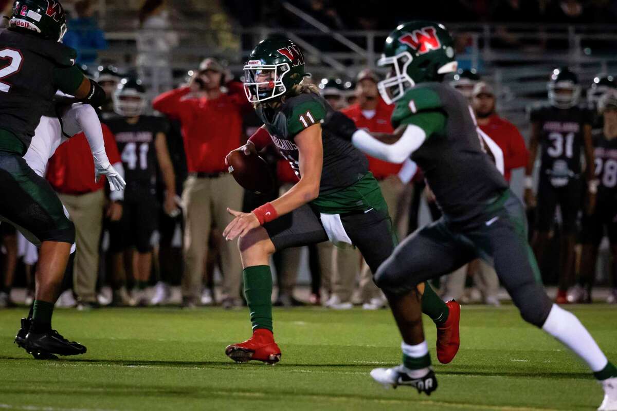 Woodlands quarterback Mabrey Mettauer (11) scrambles for a first down in the first half of a Class 6A Division I bi-district playoff game Friday, Nov 12, in Shenandoah.