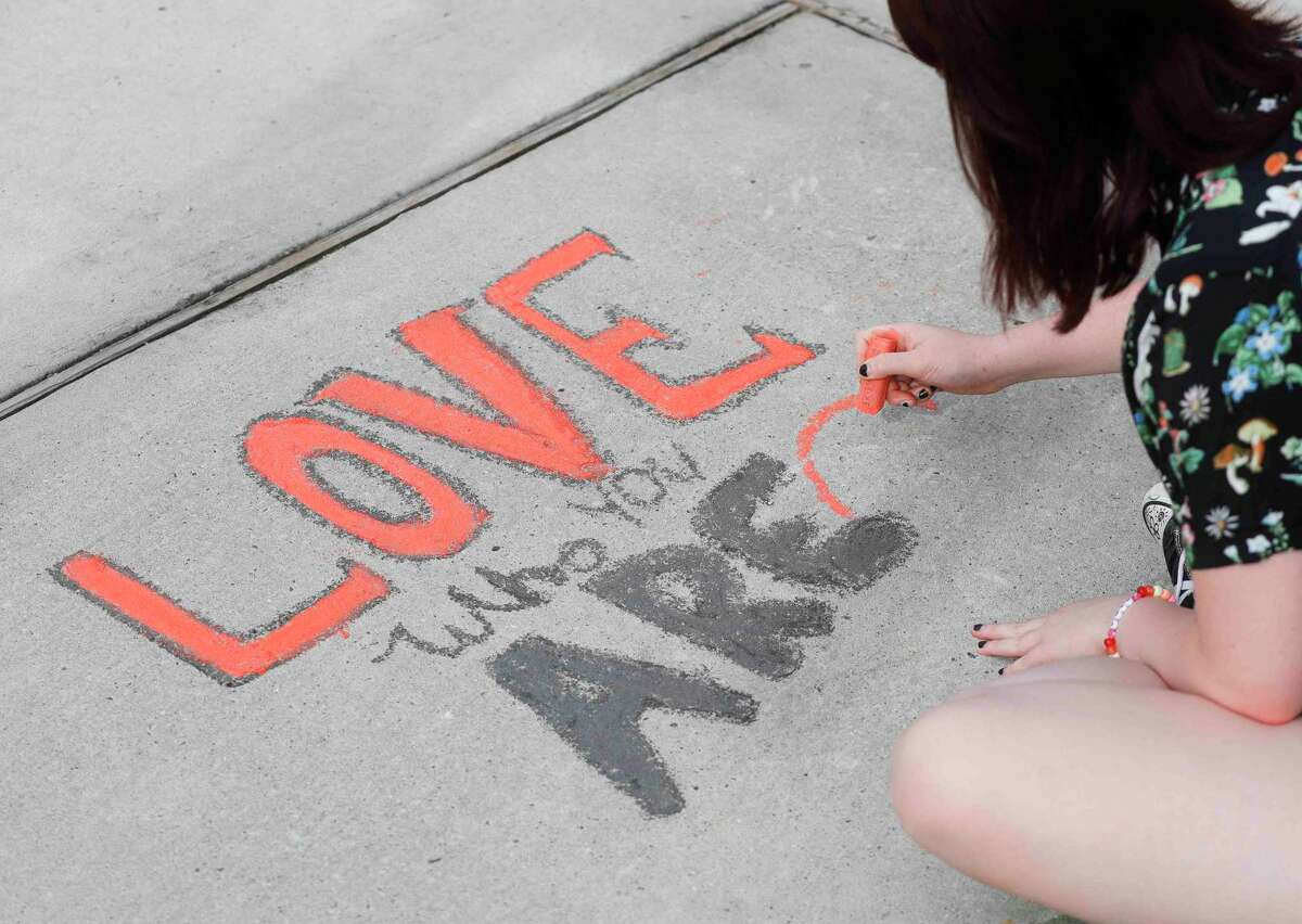 People use chalk to draw art in a public space as area youth gathered at Northshore Park to highlight awareness of Pride Month, Saturday, June 18, 2022, in The Woodlands.