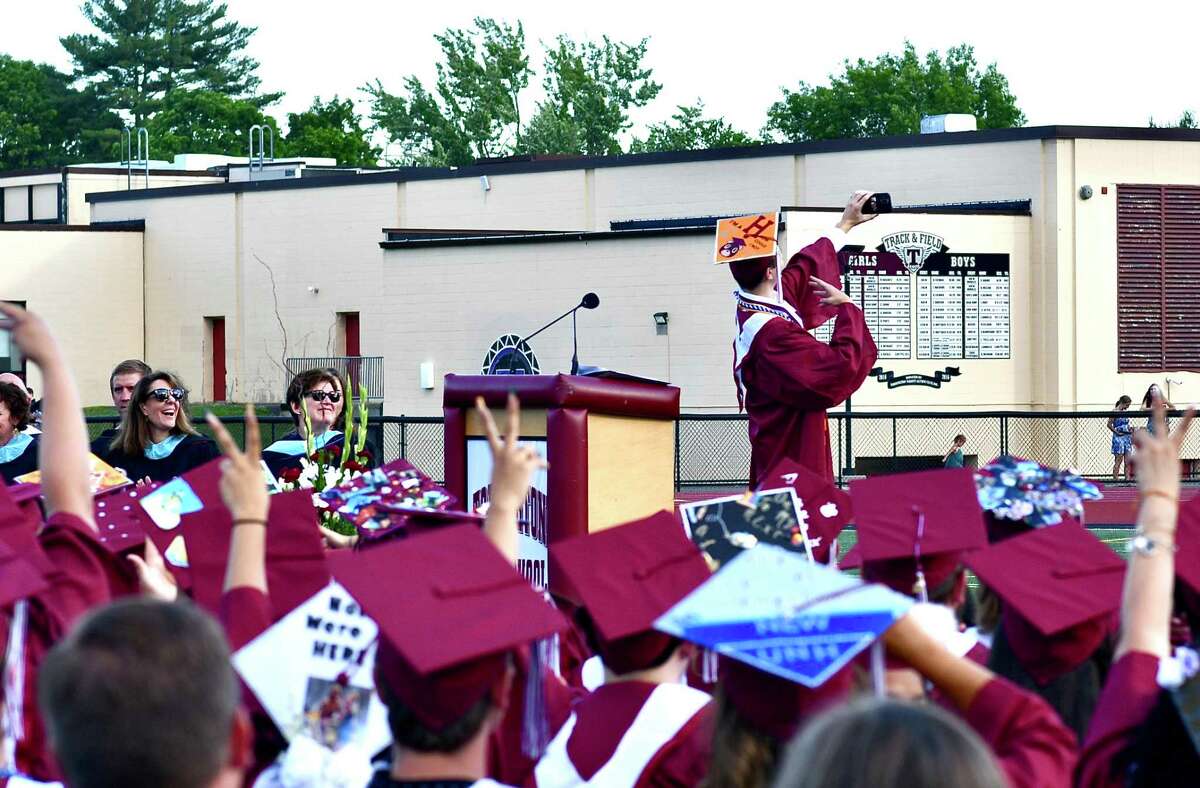 Torrington High School's class of 2022 graduated Friday, June 18. 2022. The outdoor ceremony was held on the school stadium, with hundreds of parents and friends. Class President, Logan Wilson, far right, takes a selfie with the THS class of 2022 after his speech.