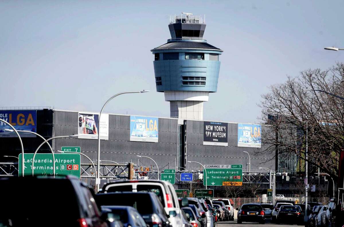 FILE - In this Friday Jan. 25, 2019, file photo is the air traffic control tower at LaGuardia Airport in New York. The tri-state area saw hundreds of incoming and outgoing flights cancelled Friday as the summer travel season picks up speed. (AP Photo/Julio Cortez, File)