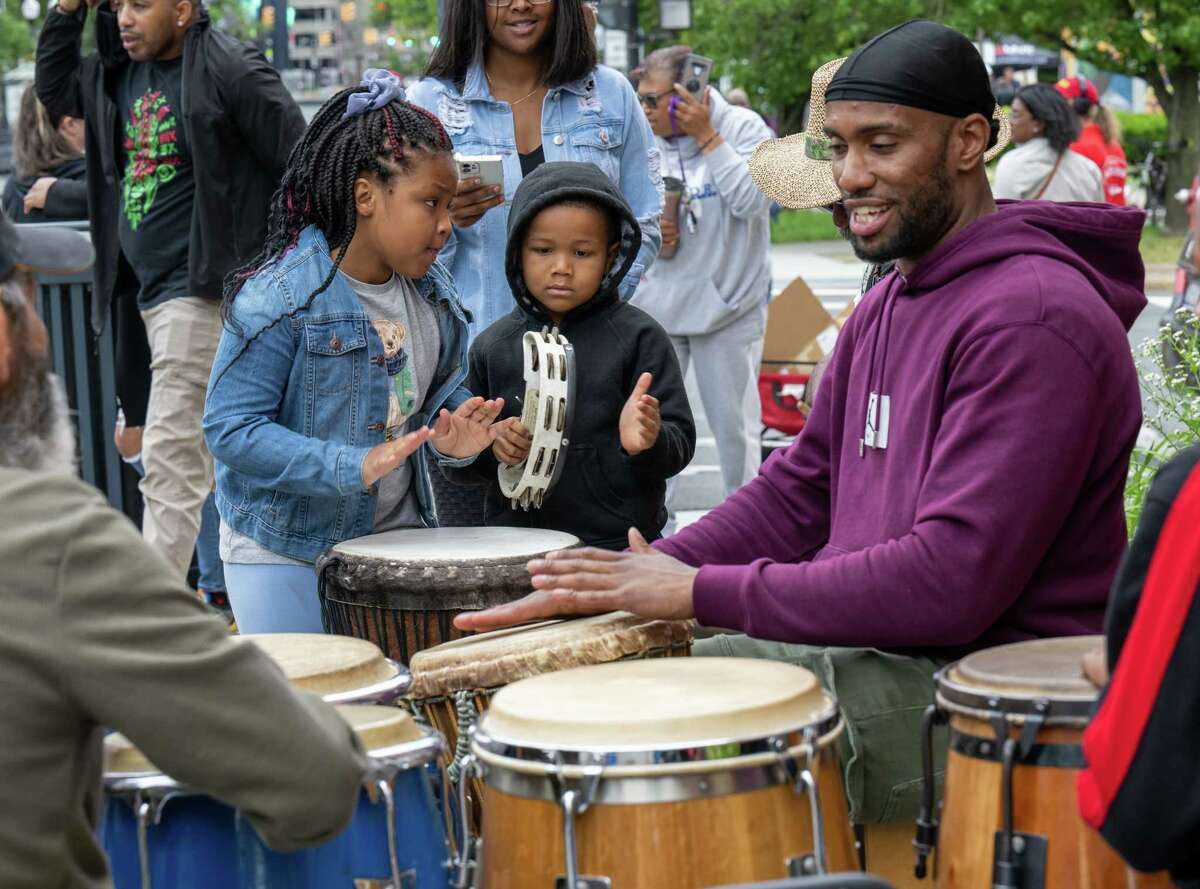 Wynter and Judah Ruiz sit in with Jordan Taylor Hill and the Washington Park Rumberos during the Juneteenth celebration Saturday, June 18, 2022, in front of the African American Cultural Center of the Capital Region on Pearl Street in Albany.