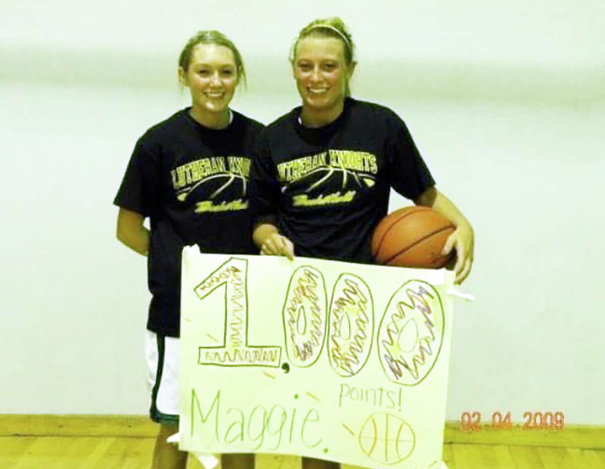 Sisters Molly Scharnhorst (left) and Maggie Scharnhorst in 2009 after Maggie scored her 1,000th career point for the Metro-East Lutheran girls basketball team.