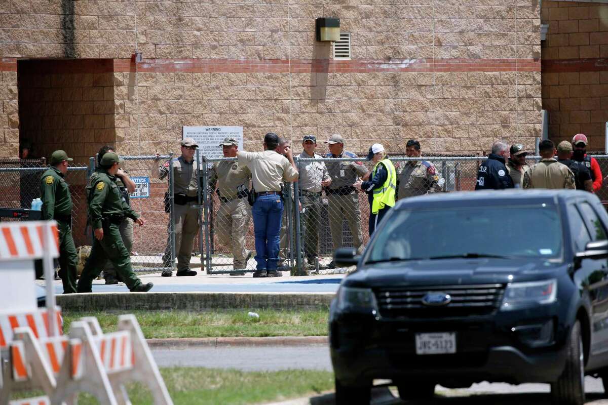 Law enforcement, and other first responders, gather outside Robb Elementary School following a shooting, Tuesday, May 24, 2022, in Uvalde, Texas. (AP Photo/Dario Lopez-Mills)