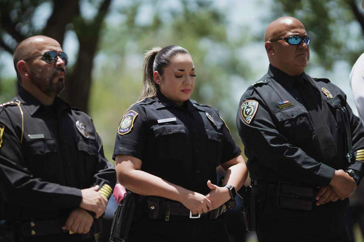 UVALDE, TX - MAY 26: A Uvalde police department officer, center, reacts as Victor Escalon, Regional Director of the Texas Department of Public Safety South, speaks during a press conference on May 26, 2022 in Uvalde, Texas. Pedro “Pete” Arredondo, the Uvalde CISD police chief is on the far right. (Photo by Eric Thayer/Getty Images)