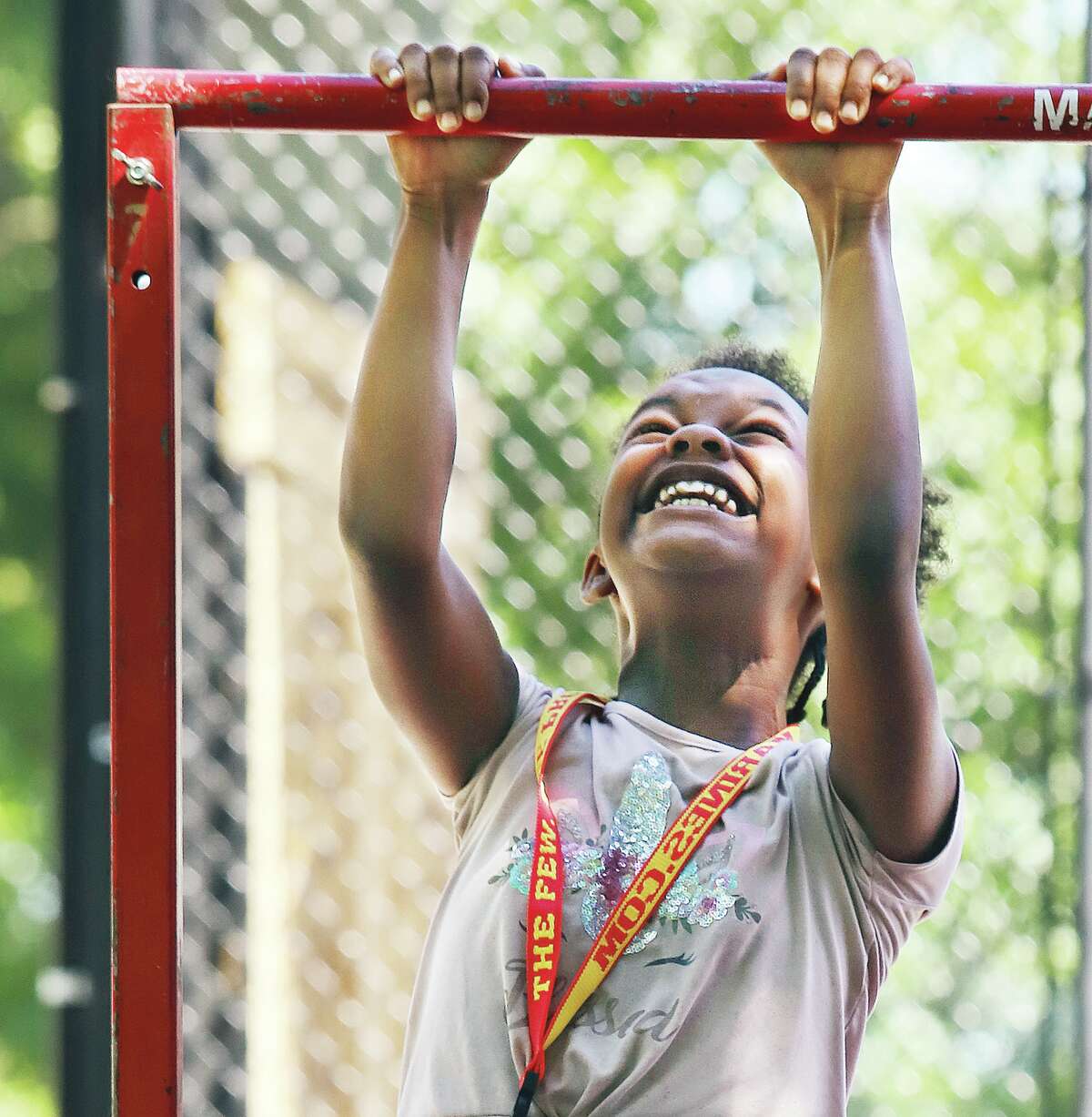 John Badman|The Telegraph Accepting a challenge from U.S. Marine recruiters, Ahmaya Shaw, 10, of East Alton, does her best to do a chin up at the Marine's booth in Killion Park.