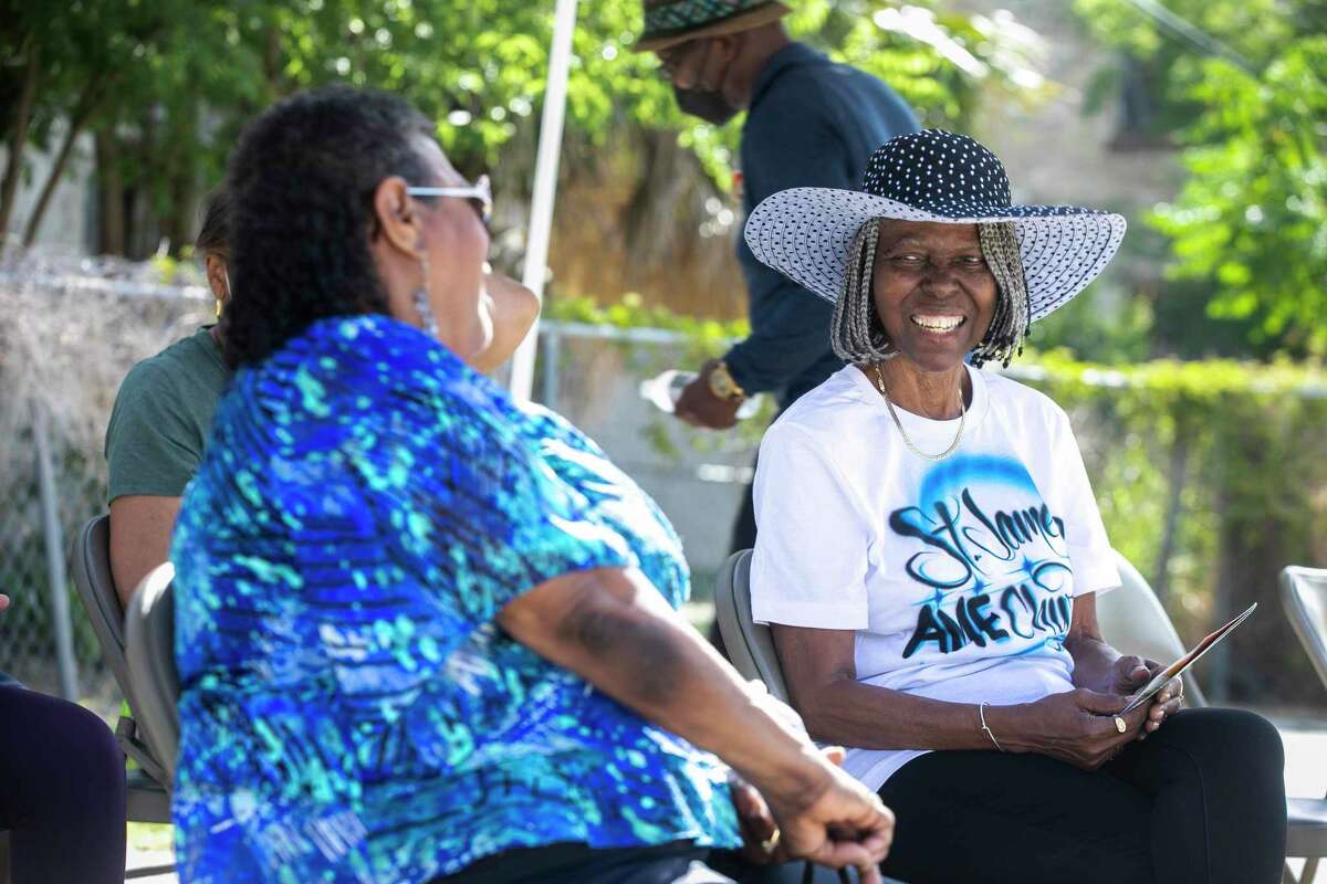 Dolorse Hines smiles as she laughs with a friend outside St. James AME Church during a June 19 celebration on Saturday, June 18, 2022.