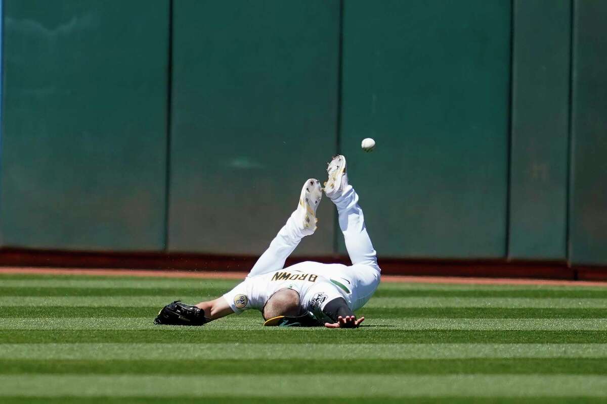 Oakland Athletics left fielder Seth Brown cannot catch a triple hit by Kansas City Royals' Michael A. Taylor during the seventh inning of a baseball game in Oakland, Calif., Saturday, June 18, 2022. (AP Photo/Jeff Chiu)