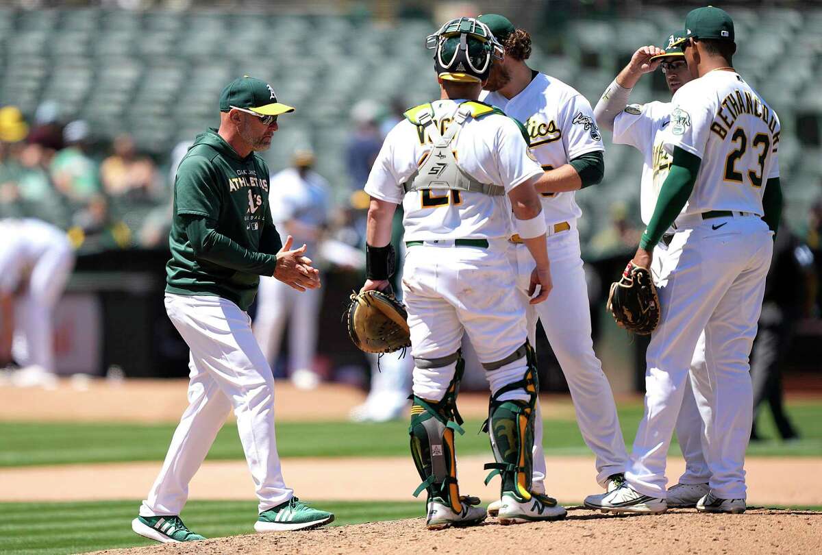 OAKLAND, CALIFORNIA - JUNE 18: Manager Mark Kotsay #7 of the Oakland Athletics walks to the mound to make a pitching change taking out Cole Irvin #19 against the Kansas City Royals in the top of the seventh inning at RingCentral Coliseum on June 18, 2022 in Oakland, California. (Photo by Thearon W. Henderson/Getty Images)