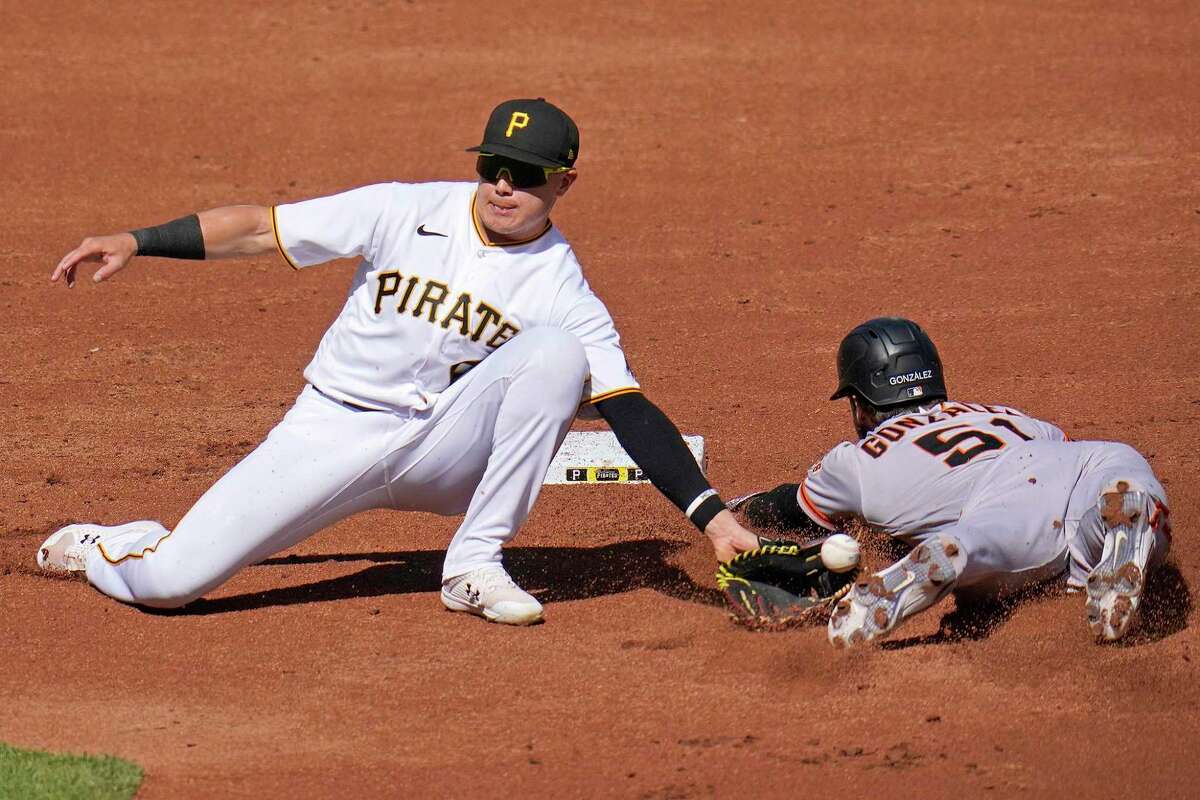 Pittsburgh Pirates second baseman Diego Castillo, left, can't handle the throw from catcher Tyler Heineman, as San Francisco Giants' Luis Gonzalez (51) safely steals second base during the second inning of a baseball game in Pittsburgh, Saturday, June 18, 2022. (AP Photo/Gene J. Puskar)