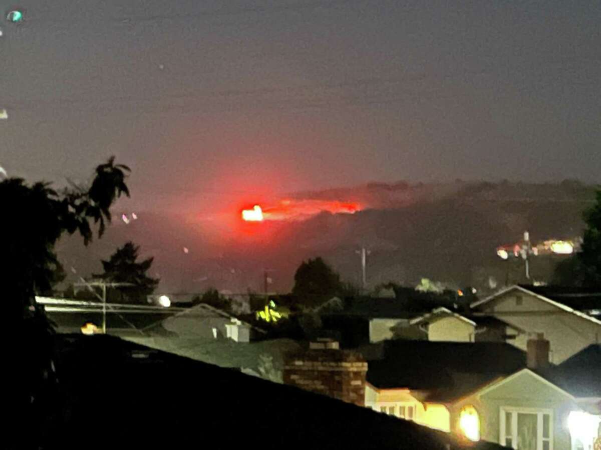 Firefighters responded to a four-alarm fire in the East Oakland hills, as seen from San Leandro.