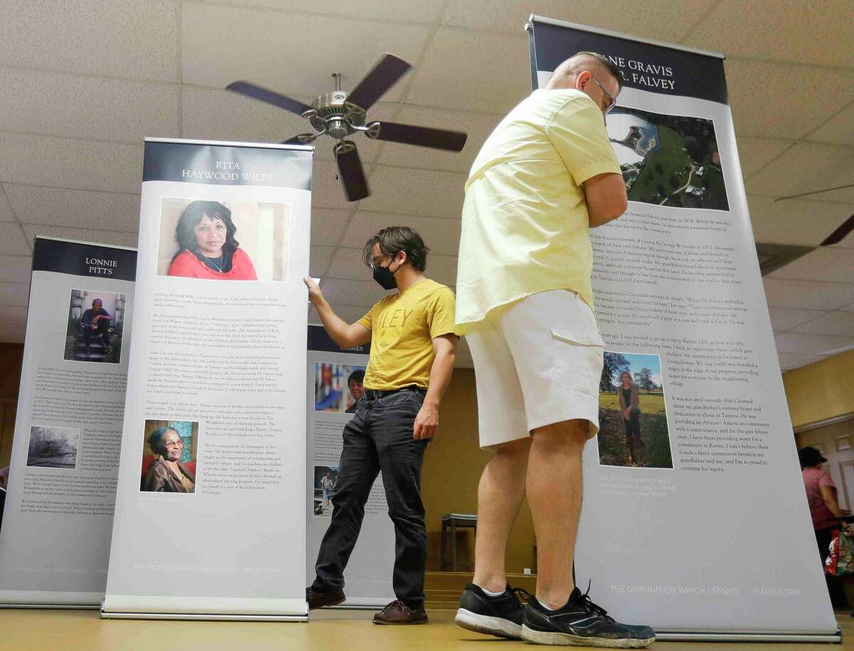 People walk through a traveling exhibit featuring historic families from Tamina, Texas’ oldest Freemen’s town, during Children’s Books on Wheels’ Juneteenth celebration, Saturday, June 18, 2022, in Tamina.