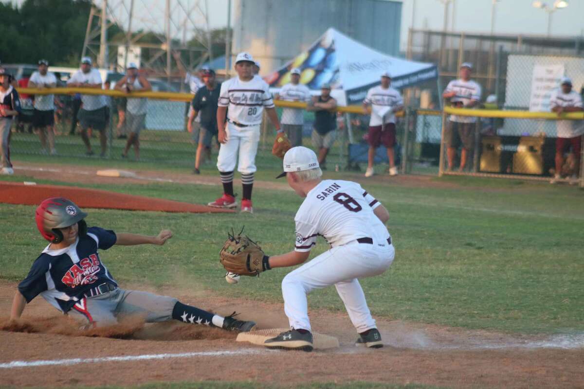 A NASA Area Little League runner slides safely into third as Colt Sabin gloves the late throw during Saturday night's District 14 game.