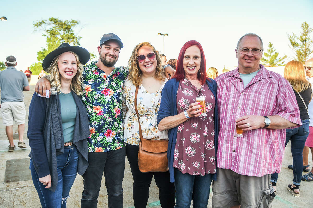 Savannah Thomas, Darin Rowe, Brandee Rowe, Cinci Thomas and Joe Thomas pose for a picture during the Tapped Downtown Midland Craft Beer Festival which took palce in the Larkin Parking Garage on June 18, 2022 in Midland.