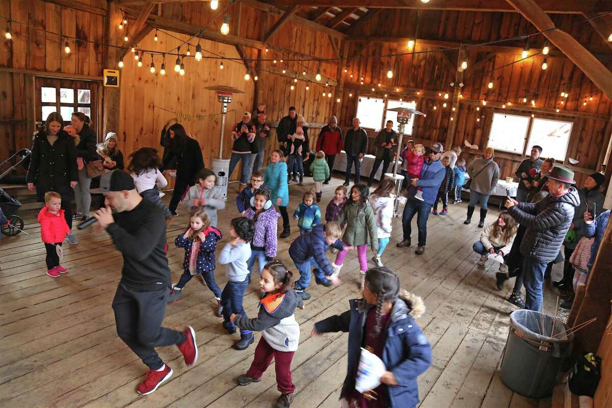 D.J. Marcell of Norwalk leads the kids in dance at the Noon Years Eve Party at Lachat Town Farm on Dec. 31, 2019 in Weston.