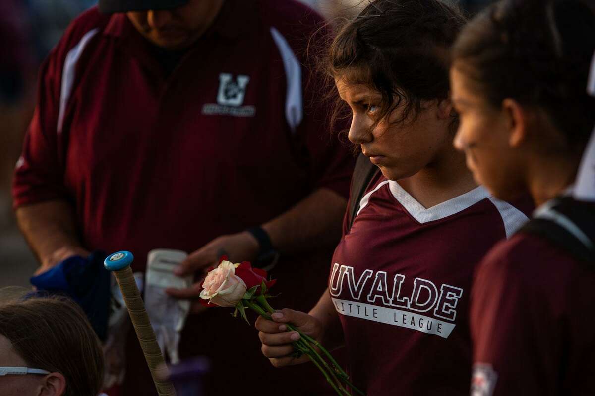 Sierra Mena (13) holds red and white roses after Saturday's game in Uvalde.
