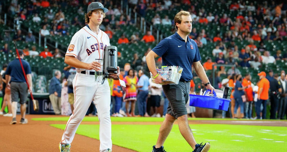 A ball boy carries a coffee machine out to the bullpen before a game between the Houston Astros and Chicago White Sox on Sunday, June 19, 2022, at Minute Maid Park in Houston.