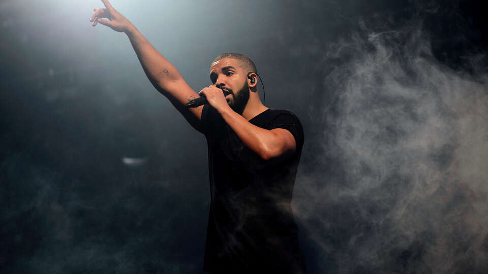 FILE - In this June 27, 2015 file photo, Canadian singer Drake performs on the main stage at Wireless festival in Finsbury Park, London. Rap has easily dominated the pop charts and on streaming services in the last few years, and thatâs reflected at the 2018 American Music Awards. Drake and Cardi B are the leading nominees with eight each. The AMAs will air live Oct. 9 from the Microsoft Theater in Los Angeles. (Photo by Jonathan Short/Invision/AP, File)
