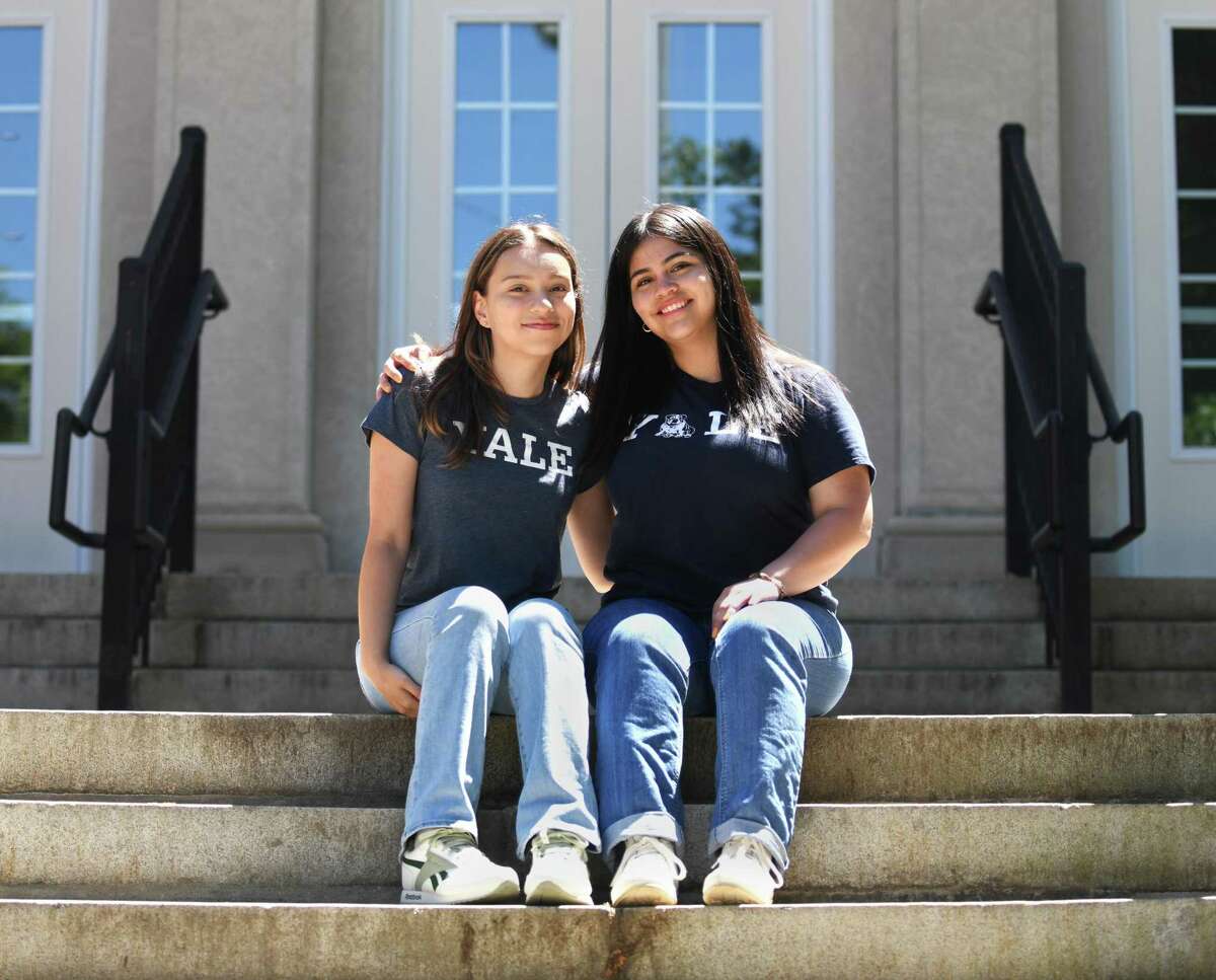 Stamford High School graduates Sara Molina, left, and Ivana Nique pose outside Stamford High School on Sunday. The two have been friends since their elementary days at Stark Elementary School and will be attending Yale University together this fall.