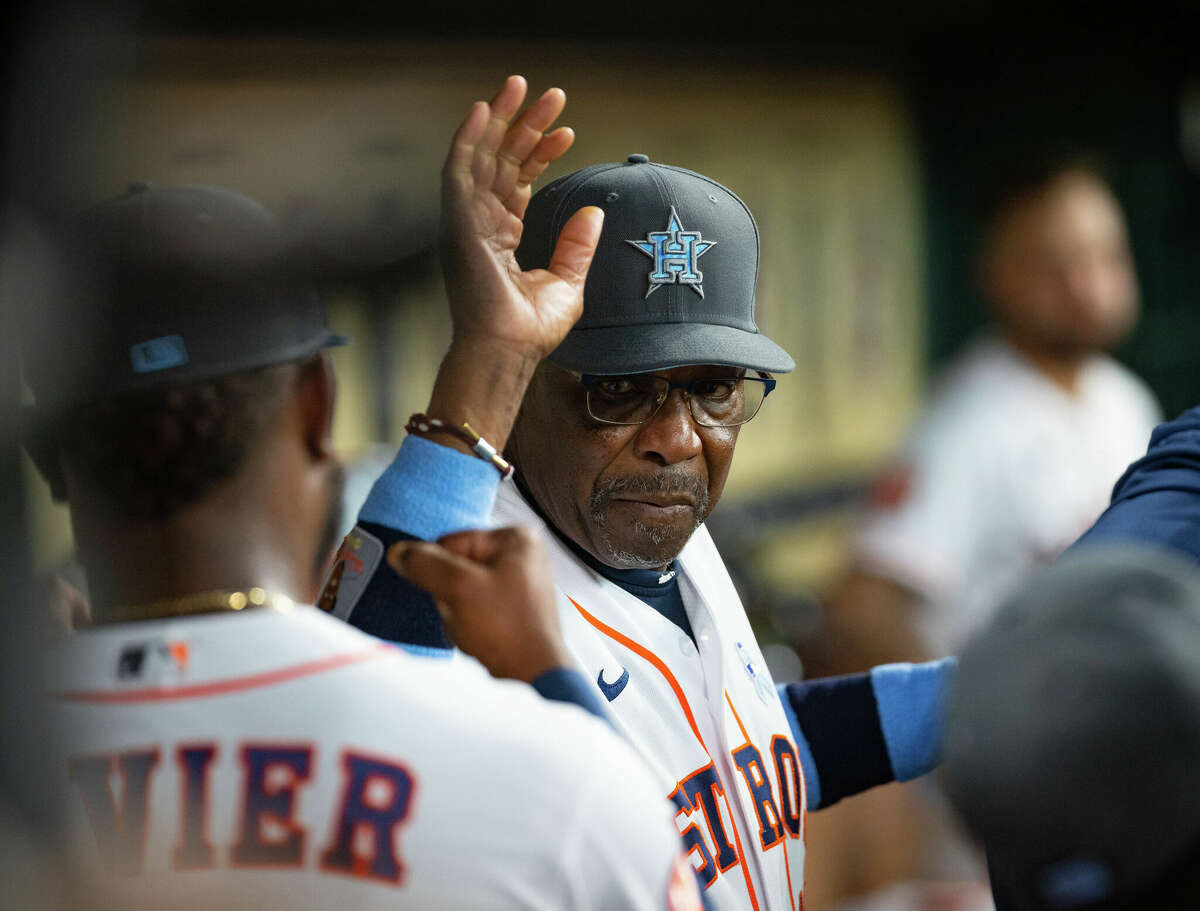 Houston Astros manager Dusty Baker Jr. (12) high fives Houston Astros starting pitcher Cristian Javier (53) during the middle of the fifth inning of a game between the Houston Astros and Chicago White Sox on Sunday, June 19, 2022, at Minute Maid Park in Houston.