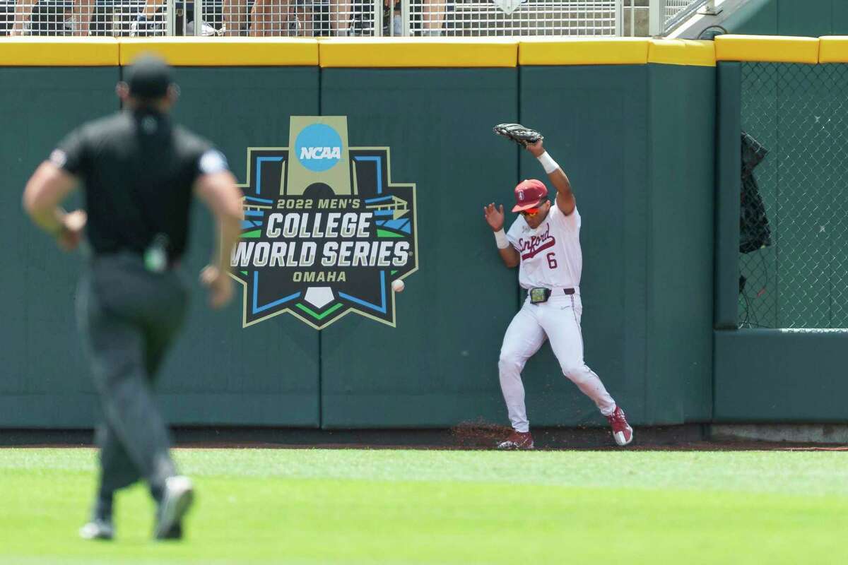 Stanford right fielder Braden Montgomery (6) misses catching the ball against Arkansas in the first inning during an NCAA College World Series baseball game Saturday, June 18, 2022, in Omaha, Neb. (AP Photo/John Peterson)