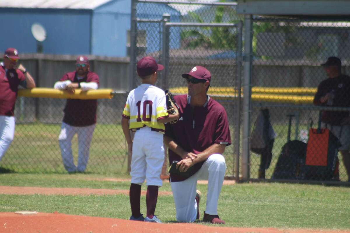 Deer Park Mustang manager Johnny Carson has a chat with pitcher Dexter Do before he departs the hill for the afternoon.