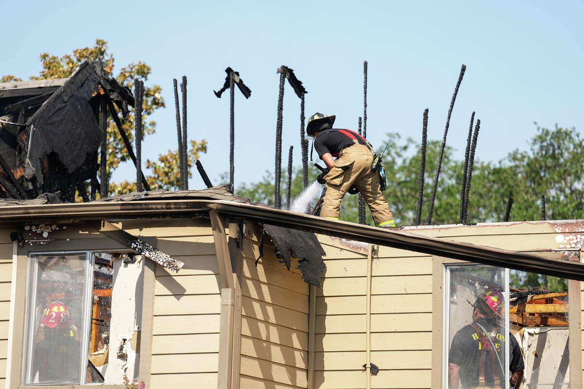 Houston firefighters work to stamp out an apartment fire in the 9900 block of Richmond Monday, June 20, 2022 in Houston. The fire was reported at about 8 a.m. Monday and heavily damaged an unspecified number of apartment units. One civilian was evaluated at the scene, but no one was transported to the hospital.