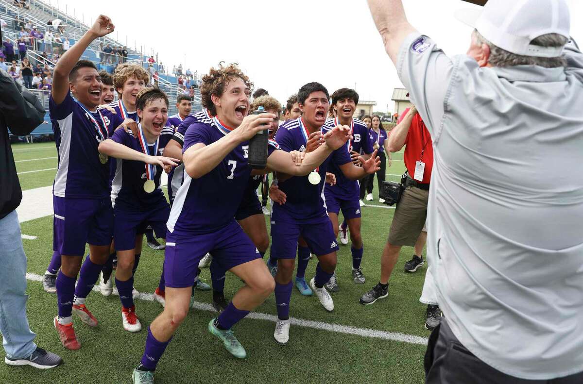 The Boerne Greyhounds boys soccer team reacts to seeing their UIL championship trophy after they defeat the Celina Bobcats in the Class 4A soccer state championship game in Georgetown on Friday, Apr. 15, 2022. Boerne defeated Celina, 2-1, in overtime to win their second and back-to-back state title.