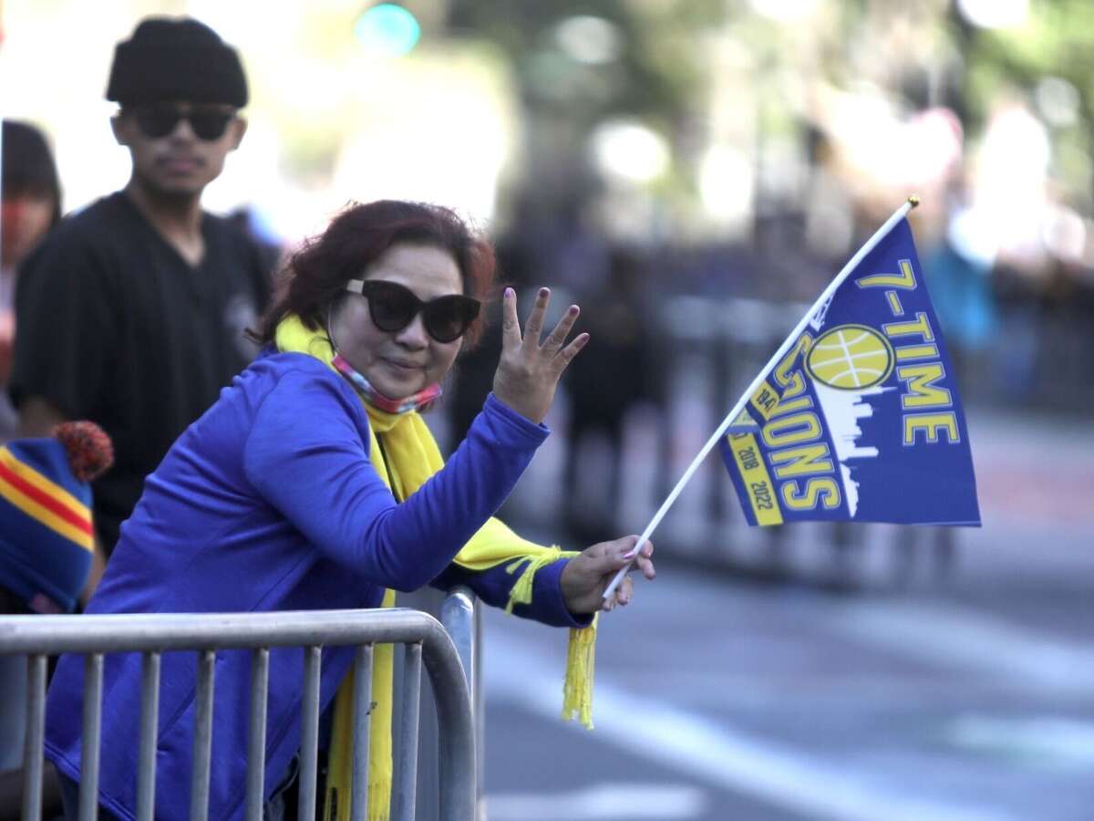Golden State Warriors fans line up along the Market Street route before the team's victory parade on June 20, 2022 in San Francisco.