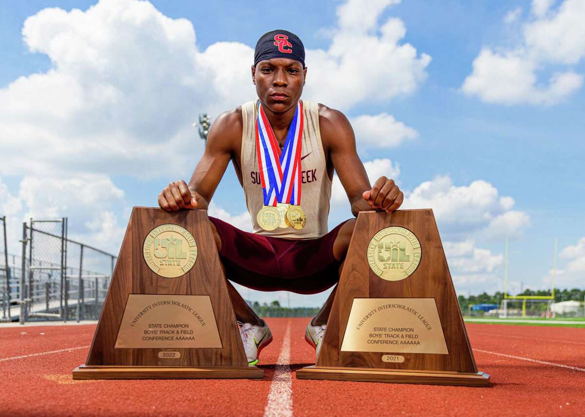 Darius Rainey poses with his UIL medals and 2021 & 2022 state championship trophies at Summer Creek High School on June 05, 2022.
