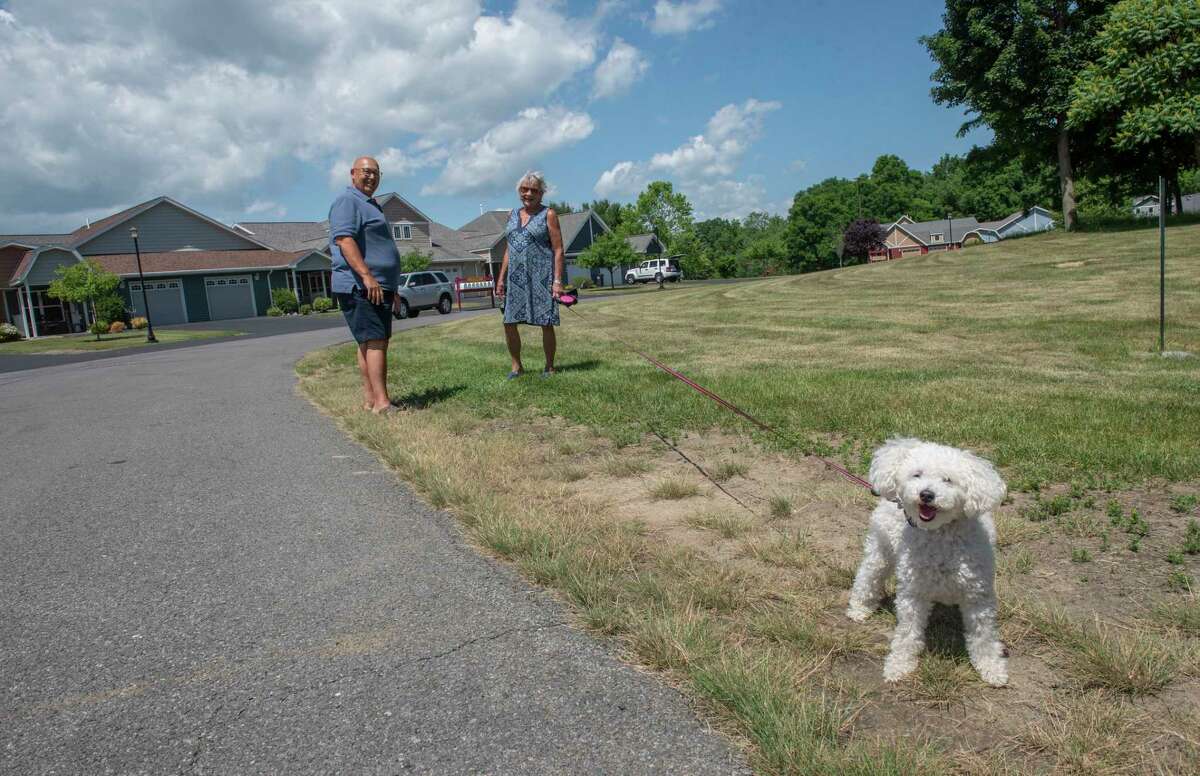 Chet Fiske stops to talk to his neighbor Patricia Kingston who was walking her dog Woody in their neighborhood at The Spinney at Pond View on Friday, June 17, 2022 in Castleton, N.Y. Fiske and his wife are retired and downsized their home.