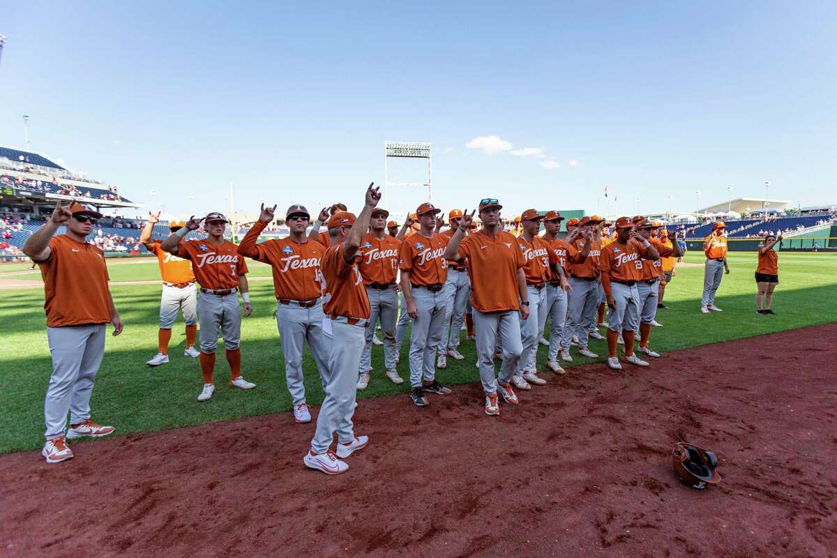 Texas sings the "Eyes of Texas" with their fans after a loss to Texas A&M in an NCAA College World Series baseball game Sunday, June 19, 2022, in Omaha, Neb. (AP Photo/John Peterson)