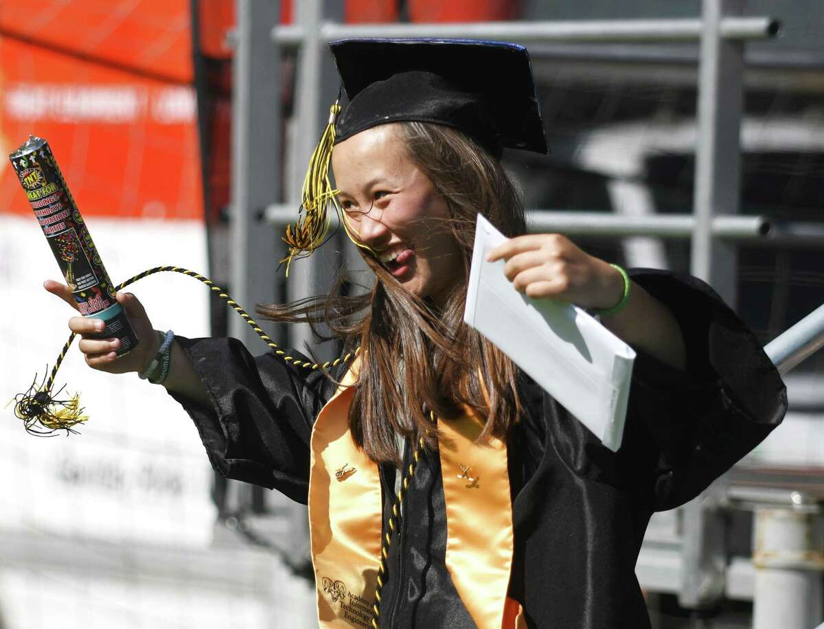 Sydney Butler celebrates after receiving her diploma at the 2022 commencement ceremony at Academy of Information Technology & Engineering magnet high school in Stamford, Conn. Monday, June 20, 2022.