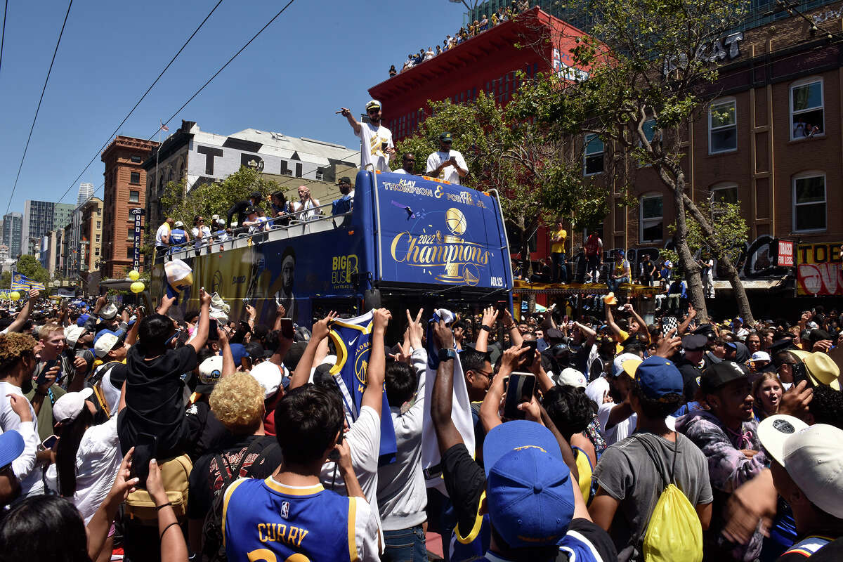 Klay Thompson waves to the crowd during the Warriors victory parade on Market Street, as fans swarmed the throughfare around his bus, on Monday June 20, 2022. 