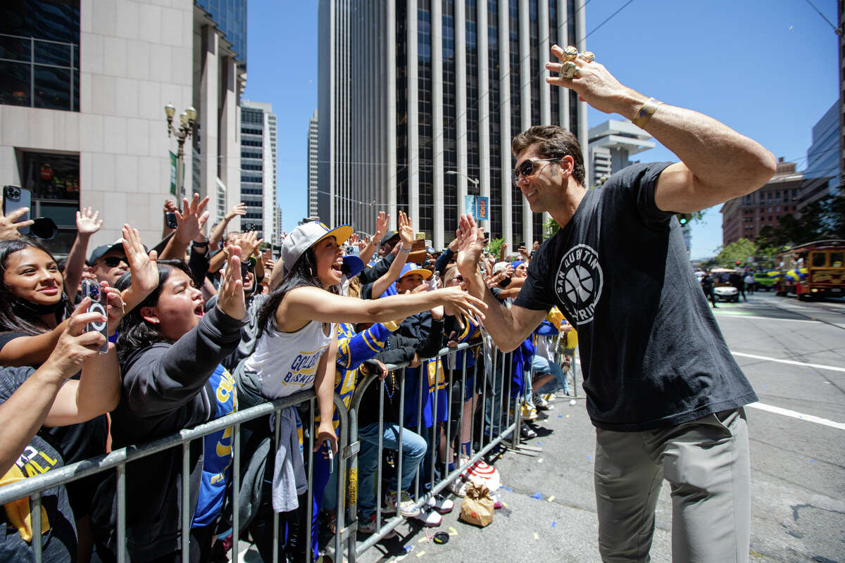 Warriors General Manager Bob Meyers hi-five fans during the Golden State Warriors Championship parade on Market Street in San Francisco, Calif.  on June 20, 2022.
