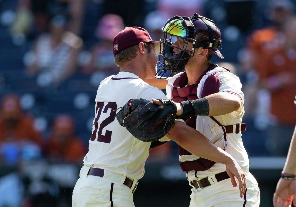 Texas A&M pitcher Brad Rudis, left, and catcher Troy Claunch helped A&M stay alive at the College World Series with Sunday’s 10-2 victory over Texas.