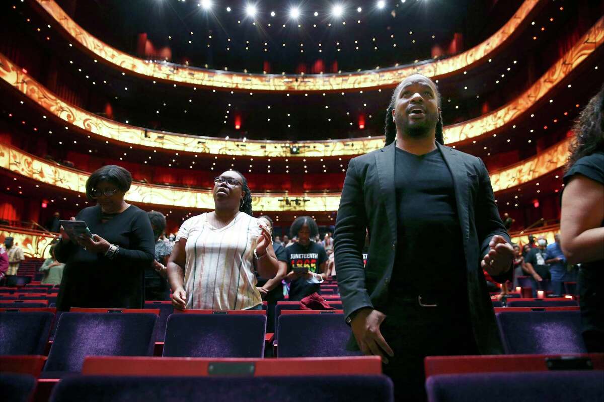 Pastor Rasool Berry (right) joins others in the singing of the Negro National Anthem as the Tobin Center marks Juneteenth on Monday, June 20, 2022.