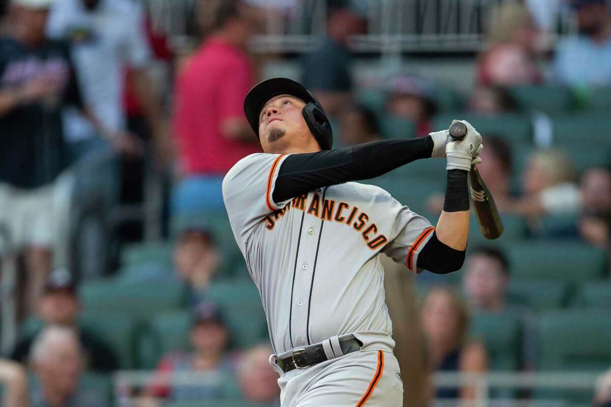 San Francisco Giants Wilmer Flores looks at a fly ball hit in the third inning of a baseball game against the Atlanta Braves Monday, June 20, 2022, in Atlanta. (AP Photo/Hakim Wright Sr.)